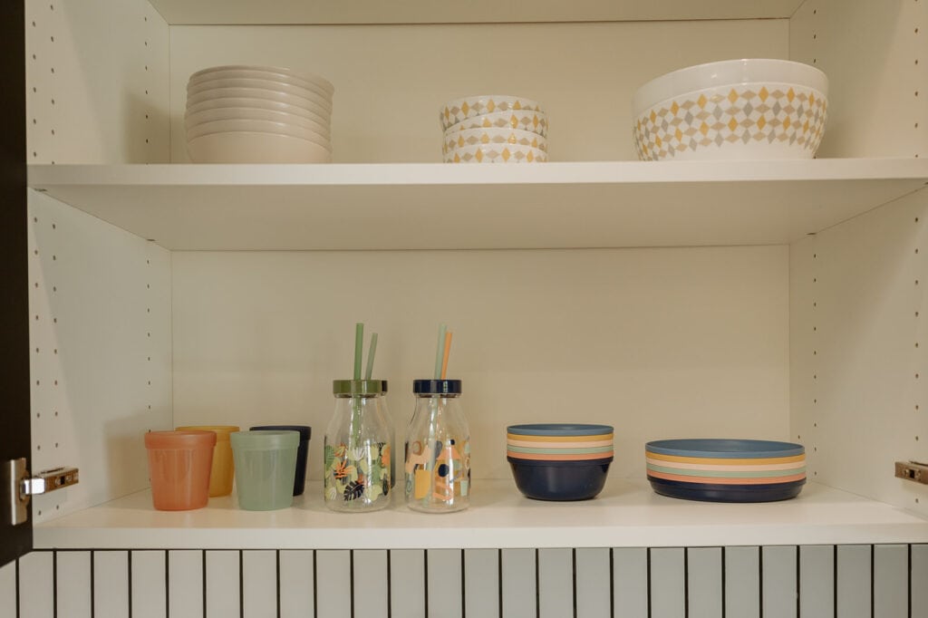 open kitchen cabinet with kids dinnerware