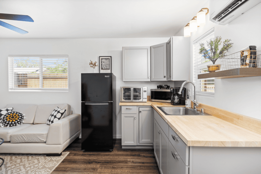 kitchenette with an apartment size refrigerator and part of a couch