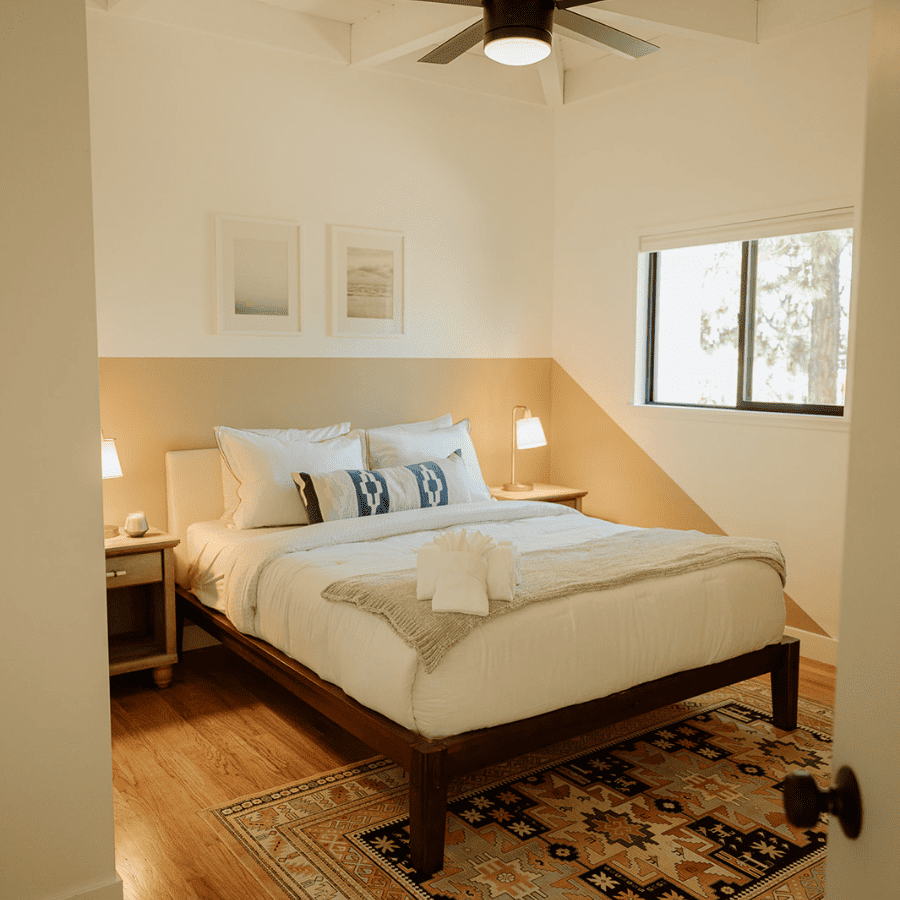 guest bedroom with queen size bed and night stands and bedside lamps