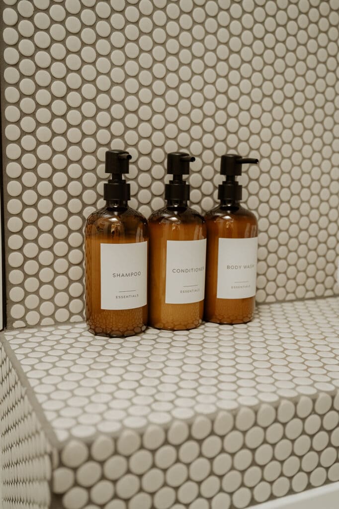 close up of shampoo, conditioner, body wash bottle in a shower