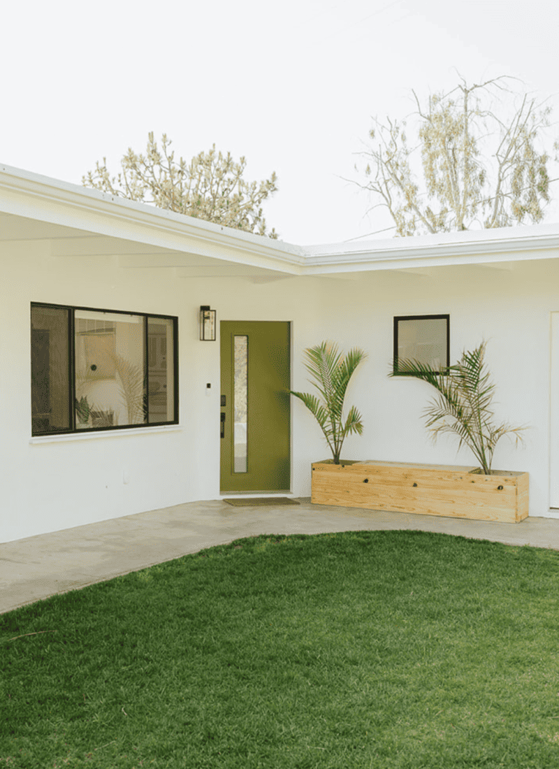 a white house with a green front door