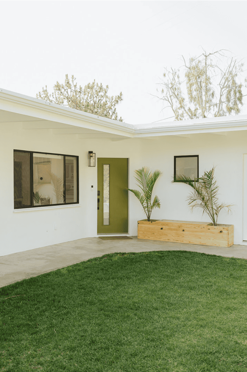 a white house with a green front door