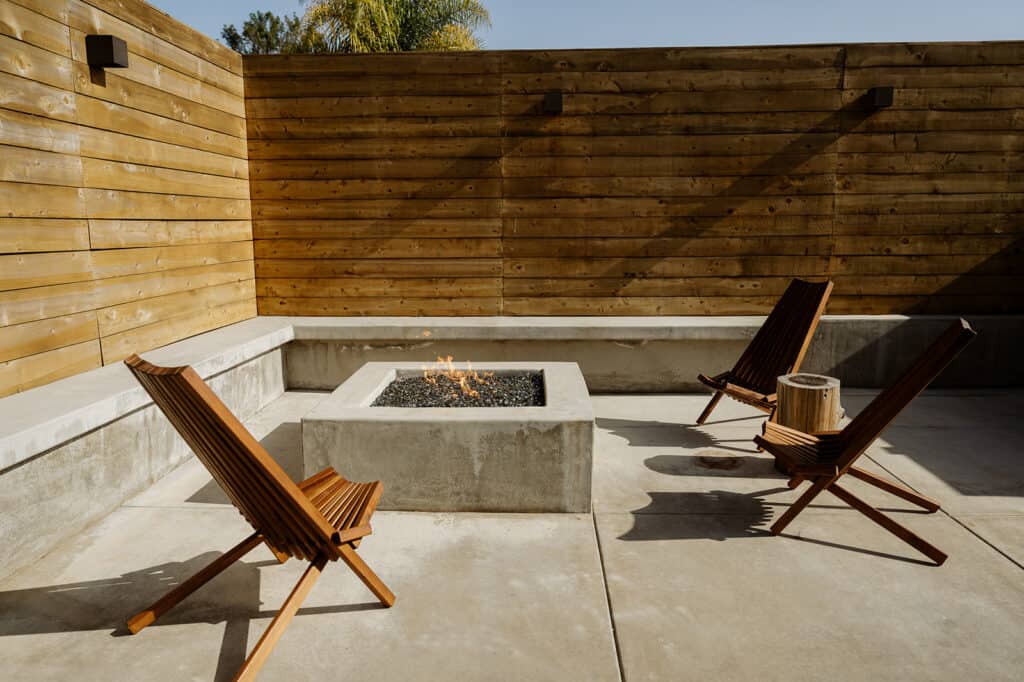 gas fire pit with chairs and a bench