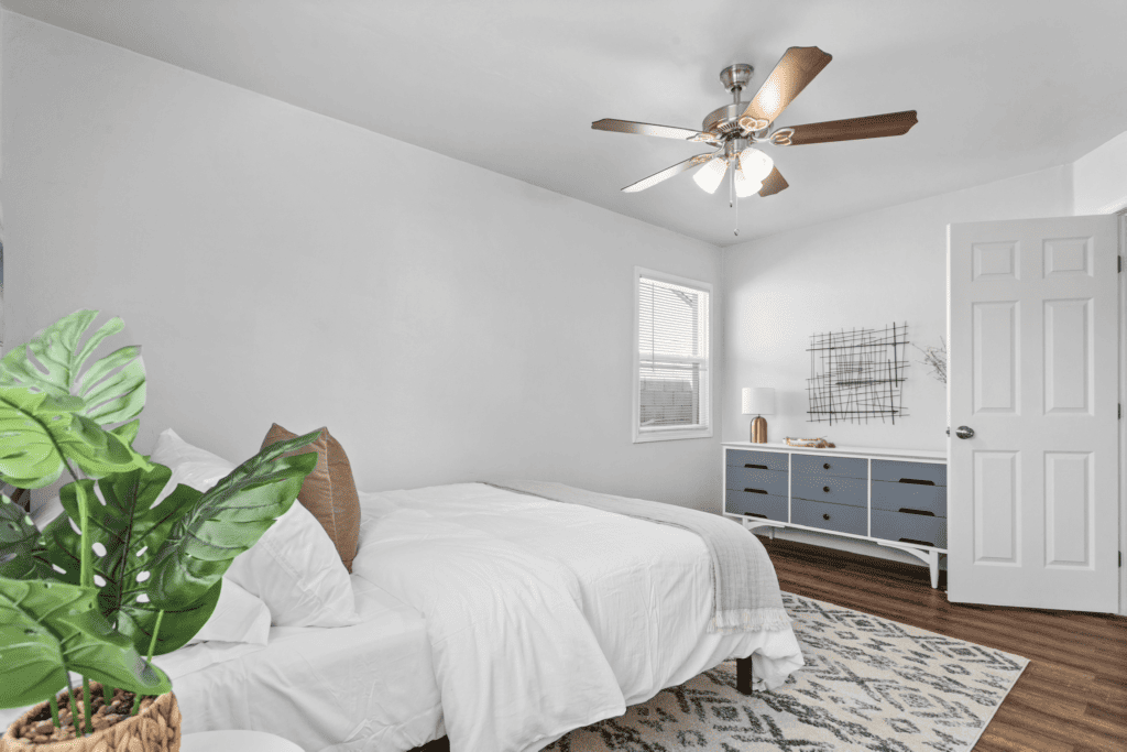 guest room with queen size bed and dresser