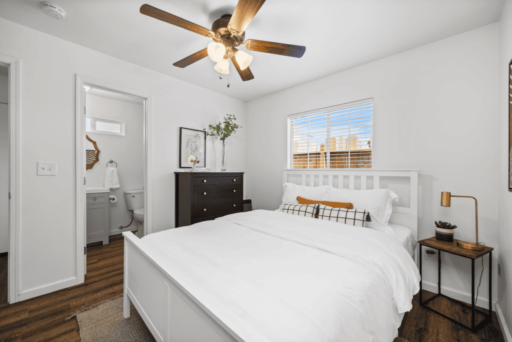 guest room with queen size bed, dresser and nightstand 