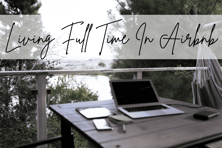 laptop that is open on an outdoor table over looking a lake